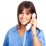 Smiling medical nurse with telephone. Isolated over white background