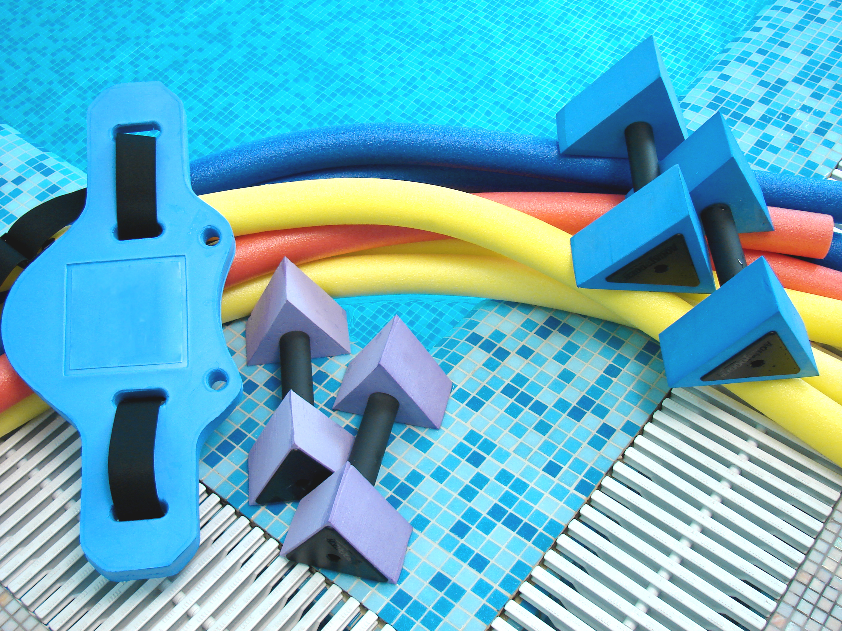 aqua noodles dumbbells belt lie on the edge of pool