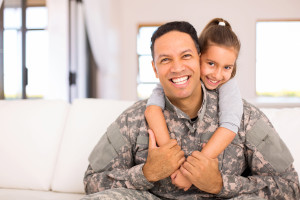 beautiful little daughter and military father at home